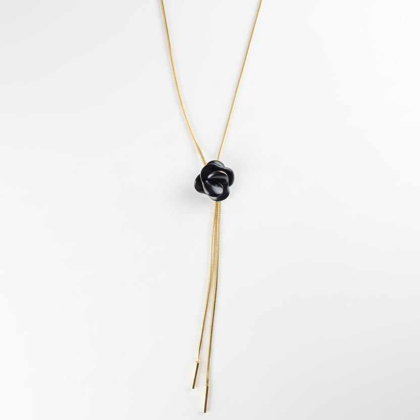 Black flower-shaped hair tie on a thin cord 