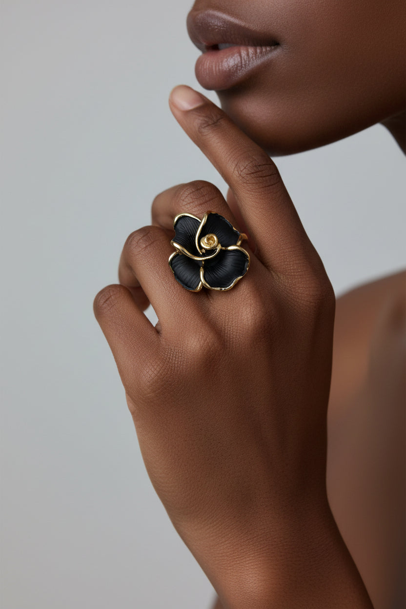 Black flower-shaped ring with gold accents 