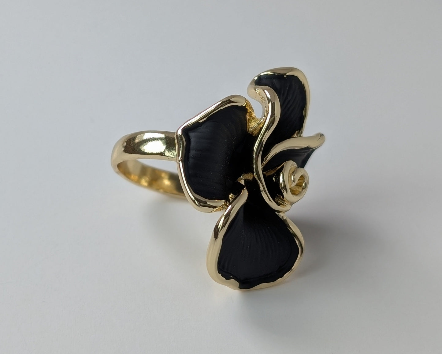 Gold ring with black flower