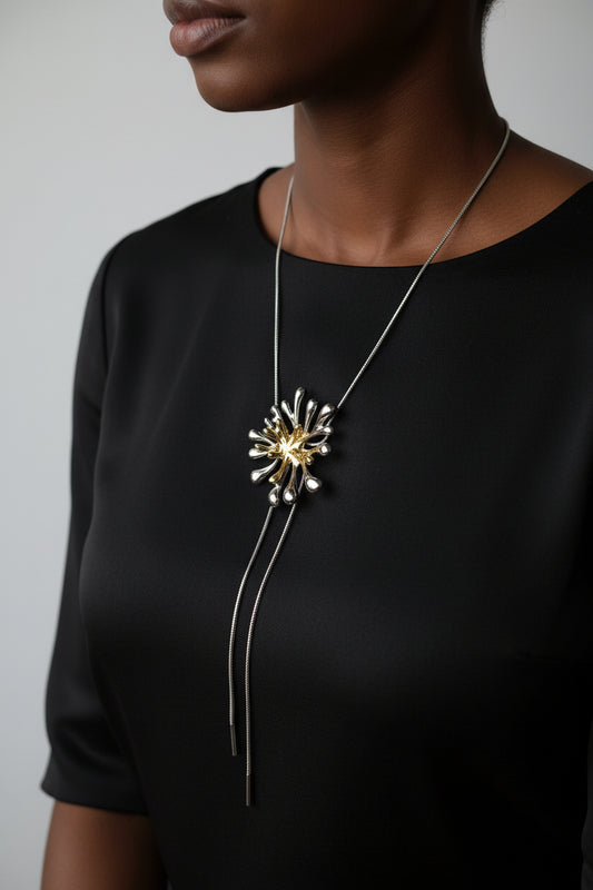 Silver necklace with a decorative flower-like two tone design 