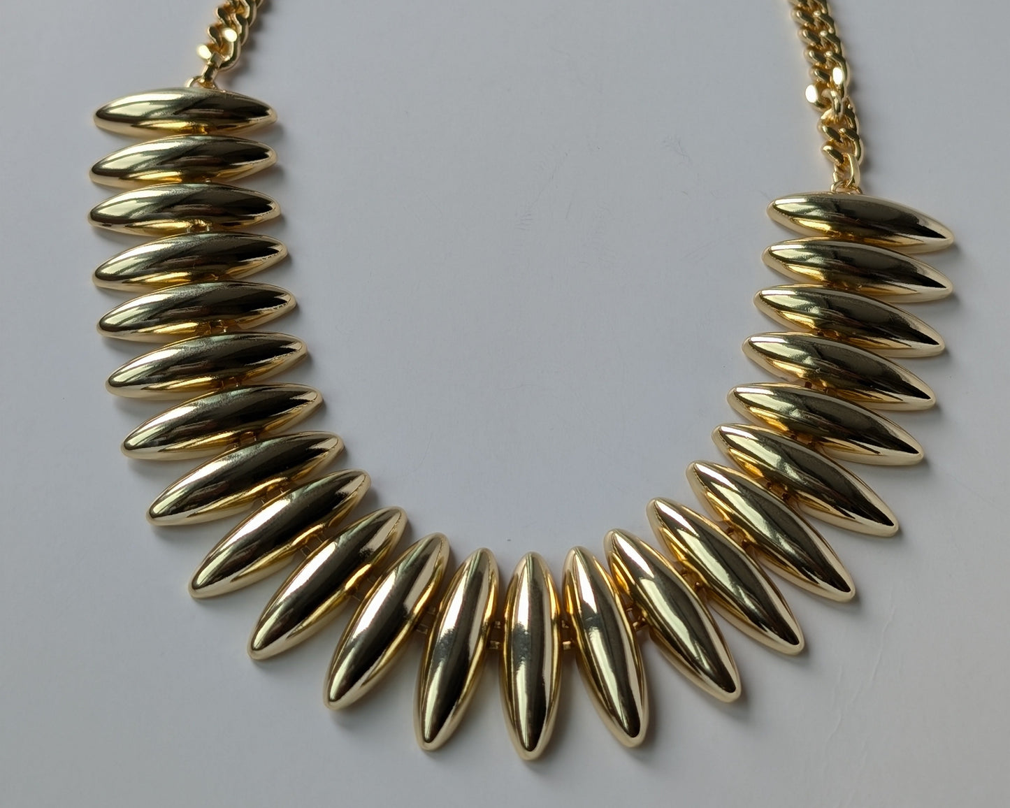 Gold necklace with spike-like design 