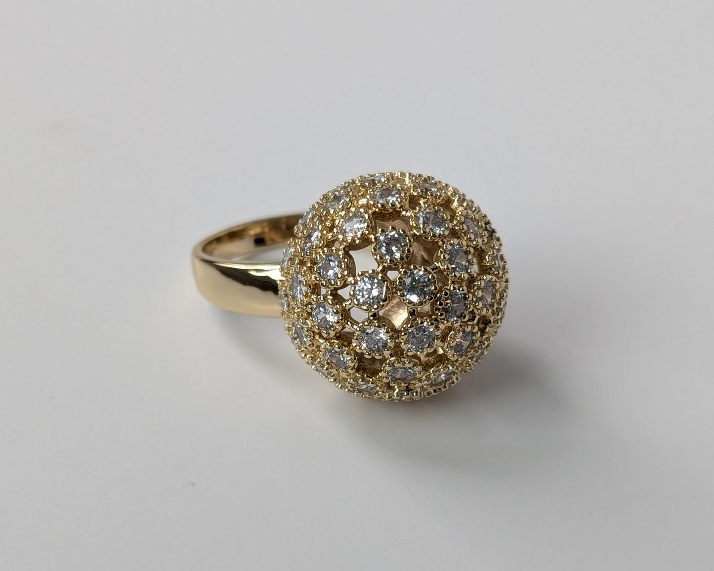 Gold ring with diamond-like dome embellishment