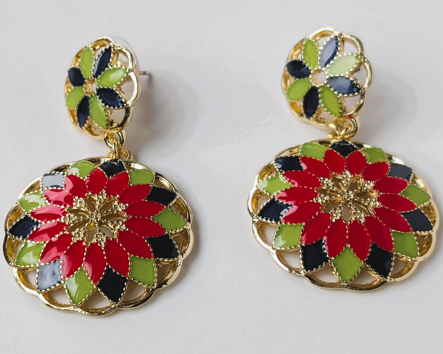 Colorful floral earrings on a light gray background