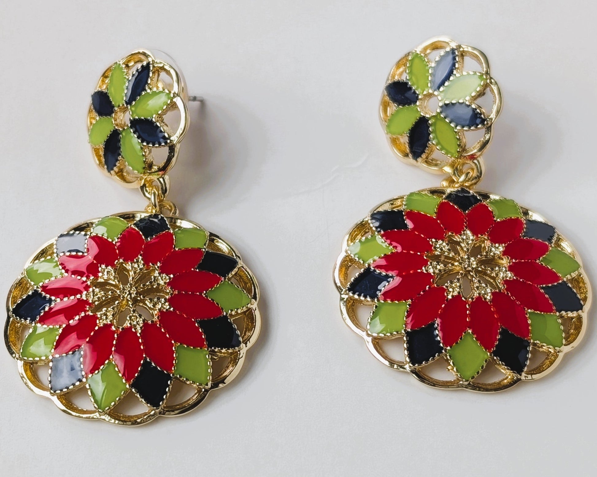Colorful floral earrings on a light gray background